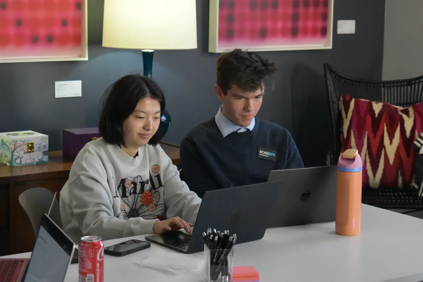 Two participants testing the prototype on a laptop