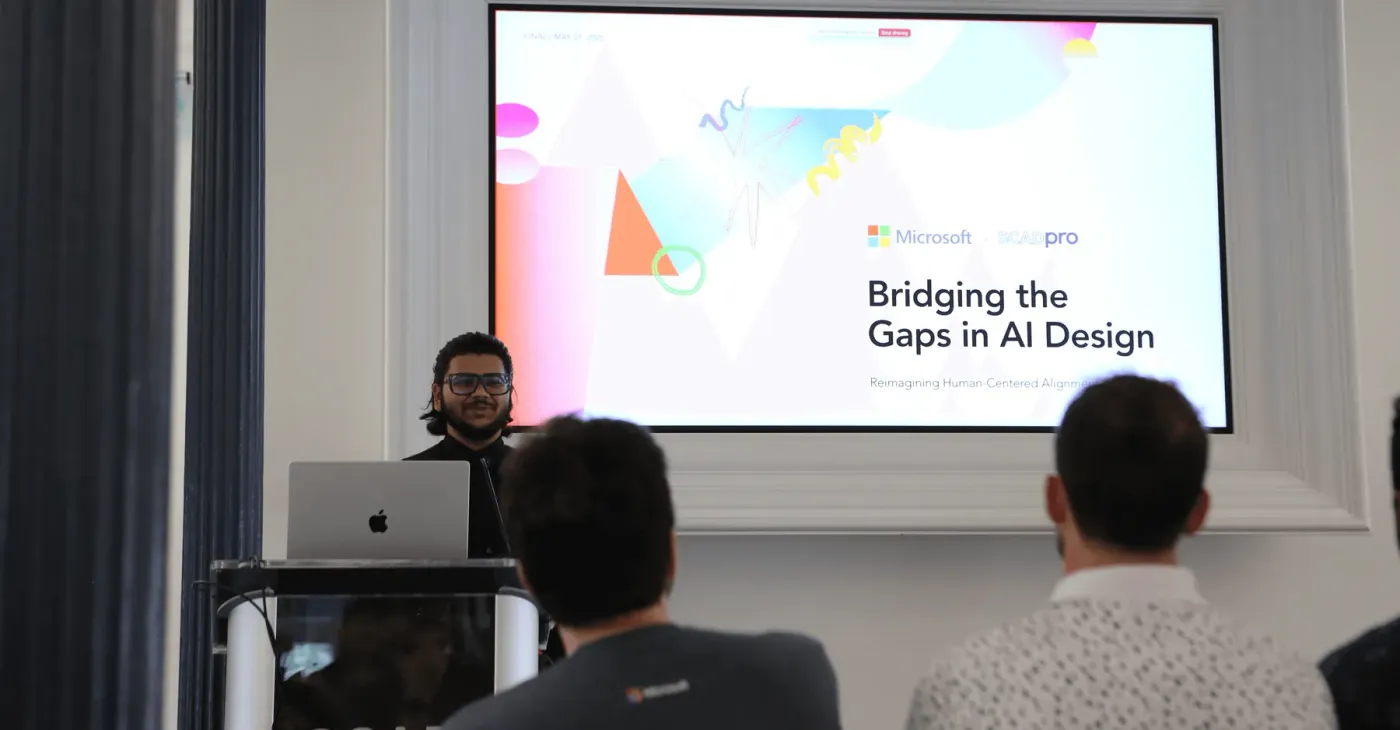 Prathamesh presenting Bridging the Gaps in AI Design, with Microsoft stakeholders in the audience