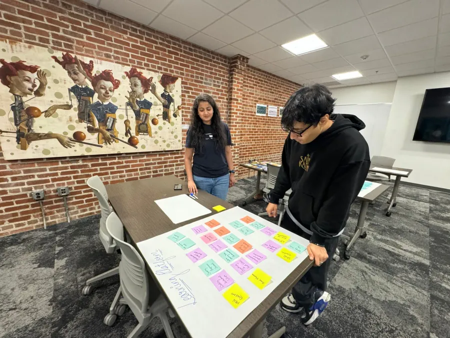 Participants exploring the Sprint activities at tables in the testing room